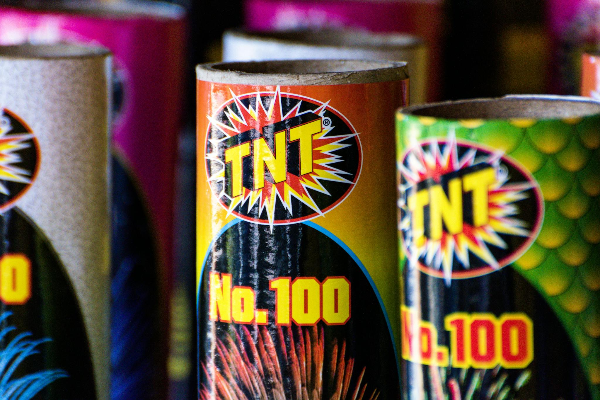 Close-up of colorful TNT fireworks tubes, showcasing vibrant packaging design.
